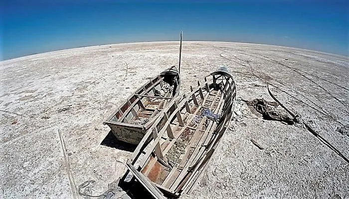 Boats are seen on the dried lake Poopo affected by climate change, in the Oruro Department, Bolivia