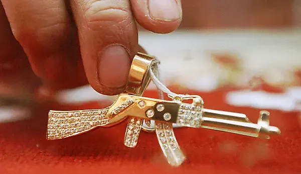 he AK-47 has become a symbol as well as a weapon, as evidenced by this diamond-encrusted pendant once owned