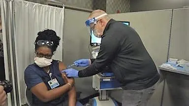 Health care workers given COVID-19 vaccine after months of tirelessly fighting virus