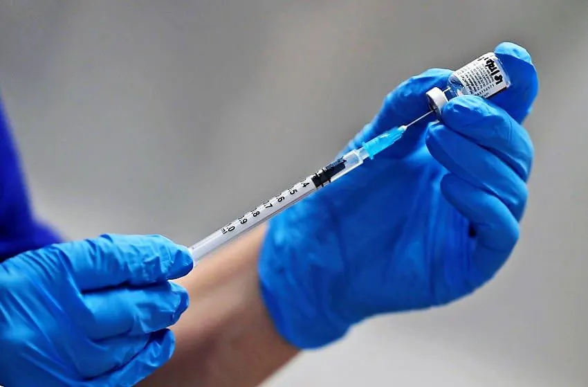 A nurse prepares to administer the Pfizer-BioNTech COVID-19 vaccine at Guy's Hospital in London, Tuesday, Dec. 8, 2020. U.K. health authorities rolled out the first doses of a widely tested and independently reviewed COVID-19 vaccine Tuesday, starting a global immunization program that is expected to gain momentum as more serums win approval.