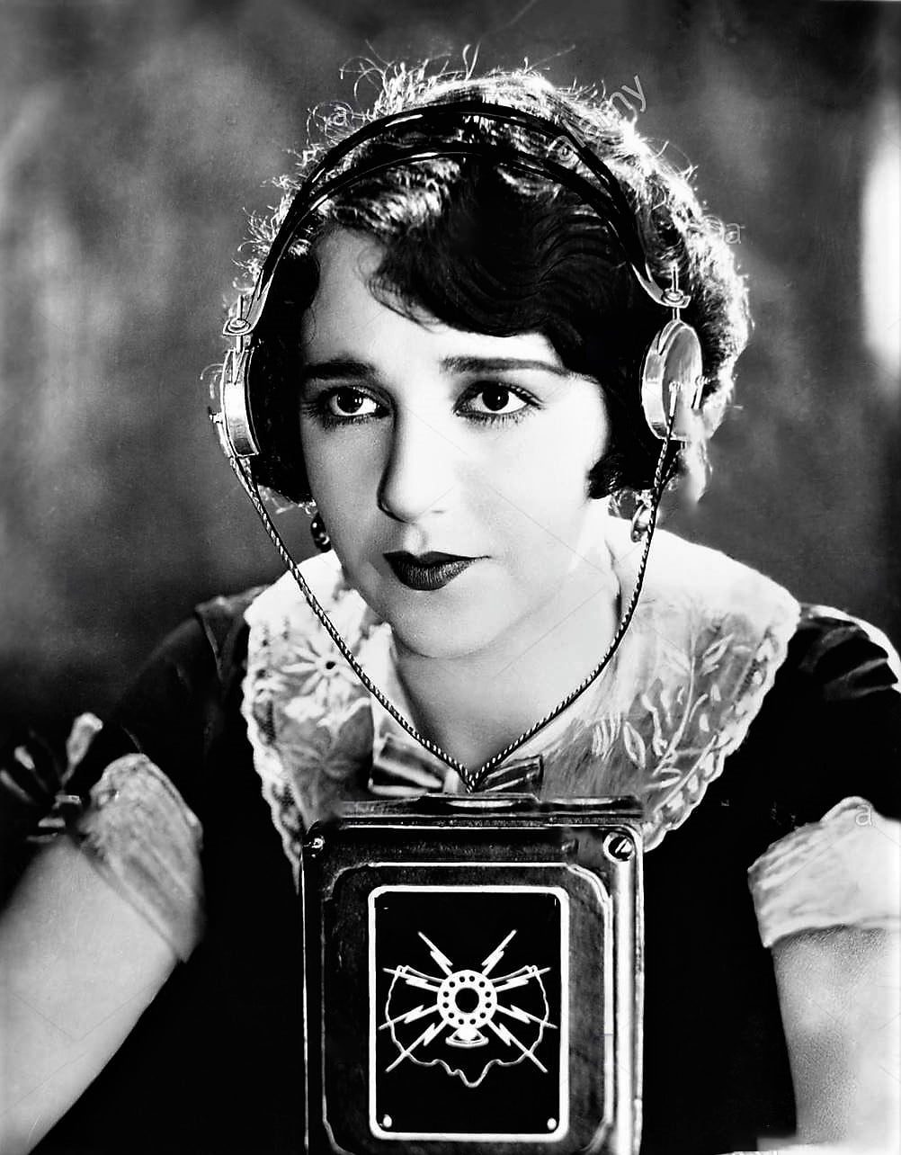 Woman wearing headphones with a microphone in front of her stock photo