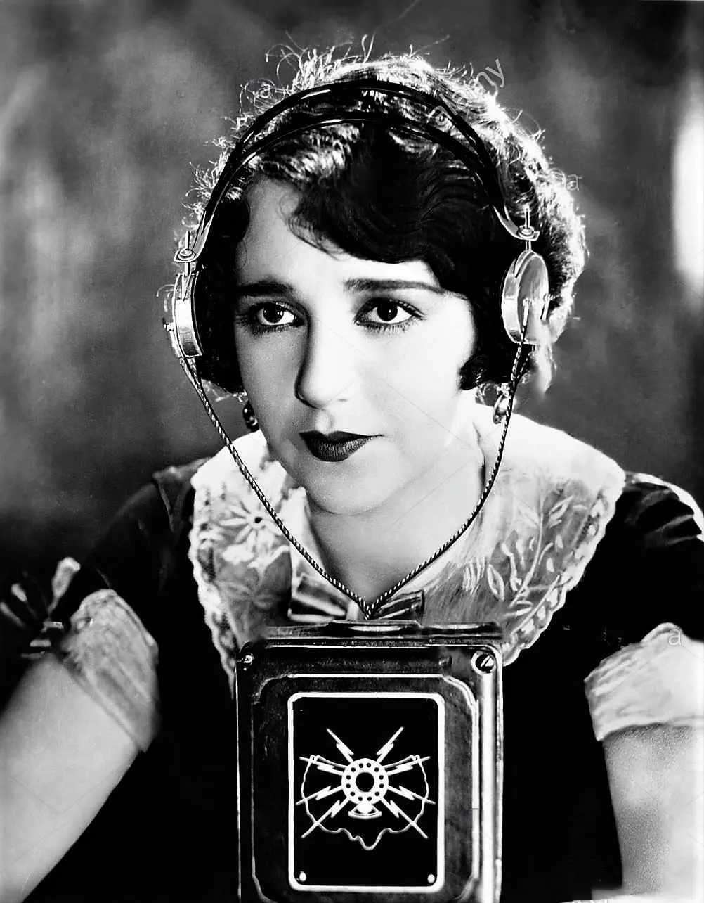 Woman wearing headphones with a microphone in front of her stock photo