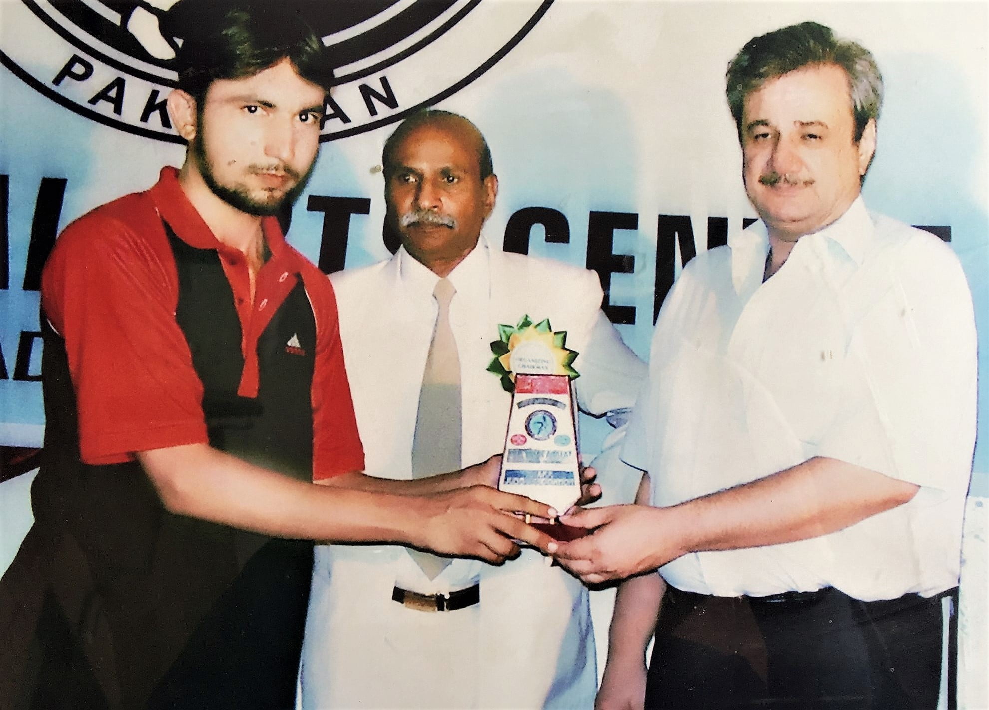 Malik Muhammad Saad giving award to a student of Karate Player